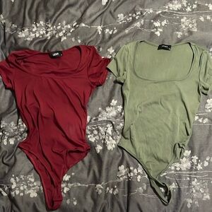 Two medium sized bodysuits from Cider